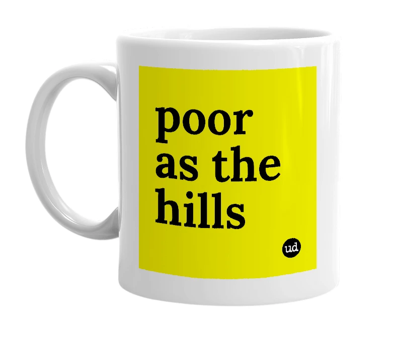 White mug with 'poor as the hills' in bold black letters