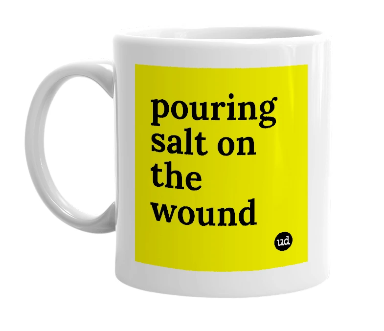White mug with 'pouring salt on the wound' in bold black letters