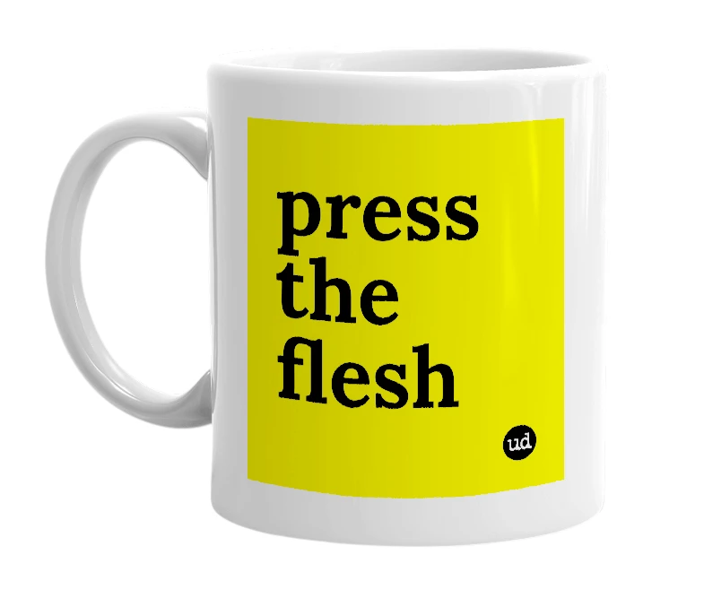 White mug with 'press the flesh' in bold black letters