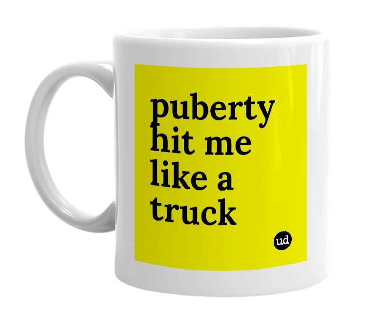 White mug with 'puberty hit me like a truck' in bold black letters
