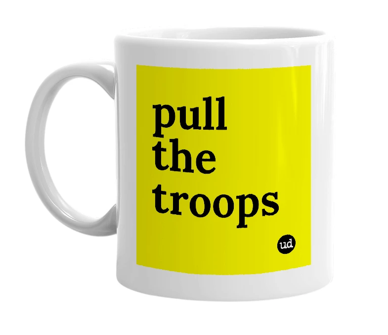 White mug with 'pull the troops' in bold black letters