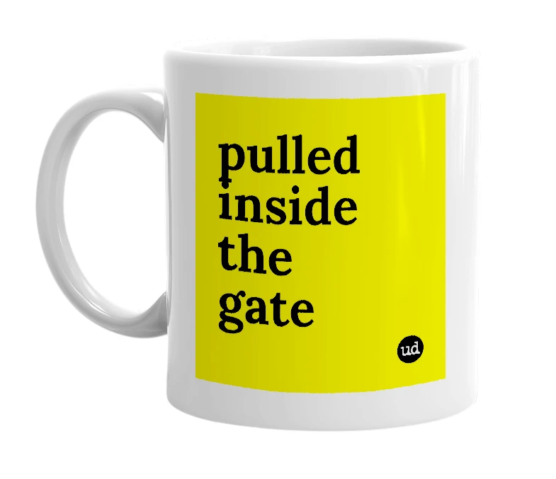 White mug with 'pulled inside the gate' in bold black letters