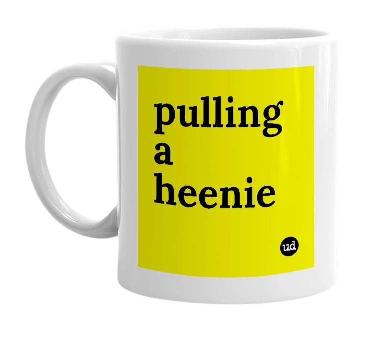 White mug with 'pulling a heenie' in bold black letters