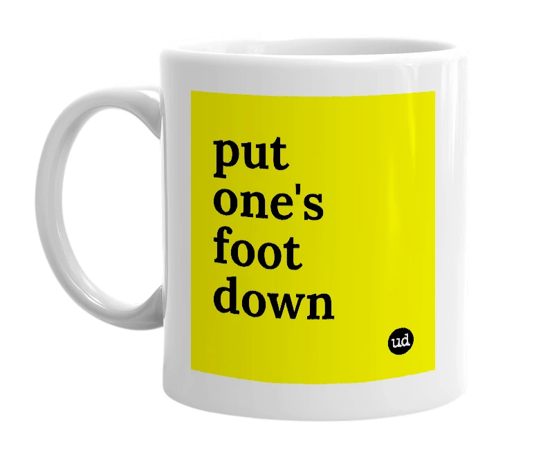 White mug with 'put one's foot down' in bold black letters