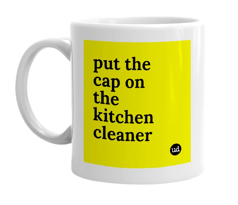 White mug with 'put the cap on the kitchen cleaner' in bold black letters