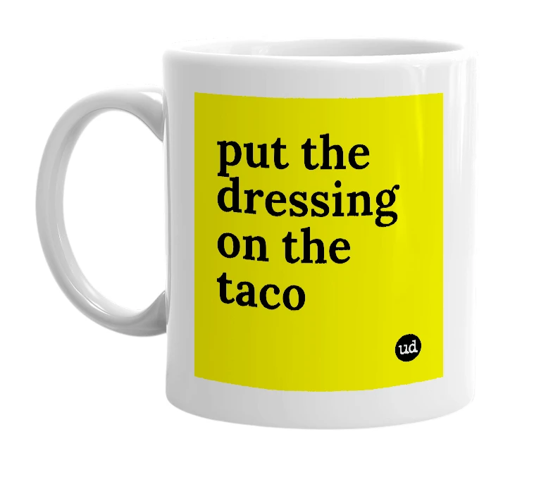 White mug with 'put the dressing on the taco' in bold black letters