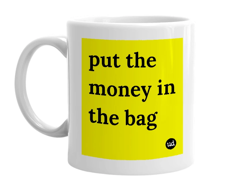 White mug with 'put the money in the bag' in bold black letters