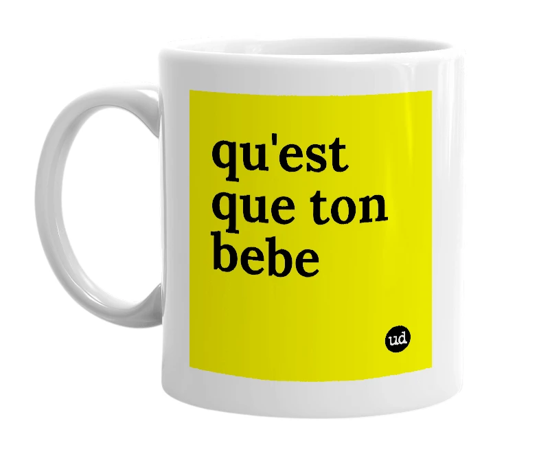 White mug with 'qu'est que ton bebe' in bold black letters