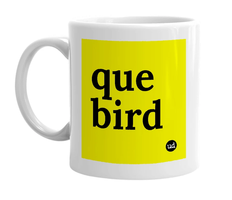 White mug with 'que bird' in bold black letters