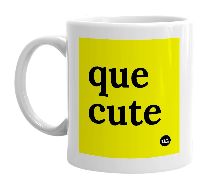 White mug with 'que cute' in bold black letters