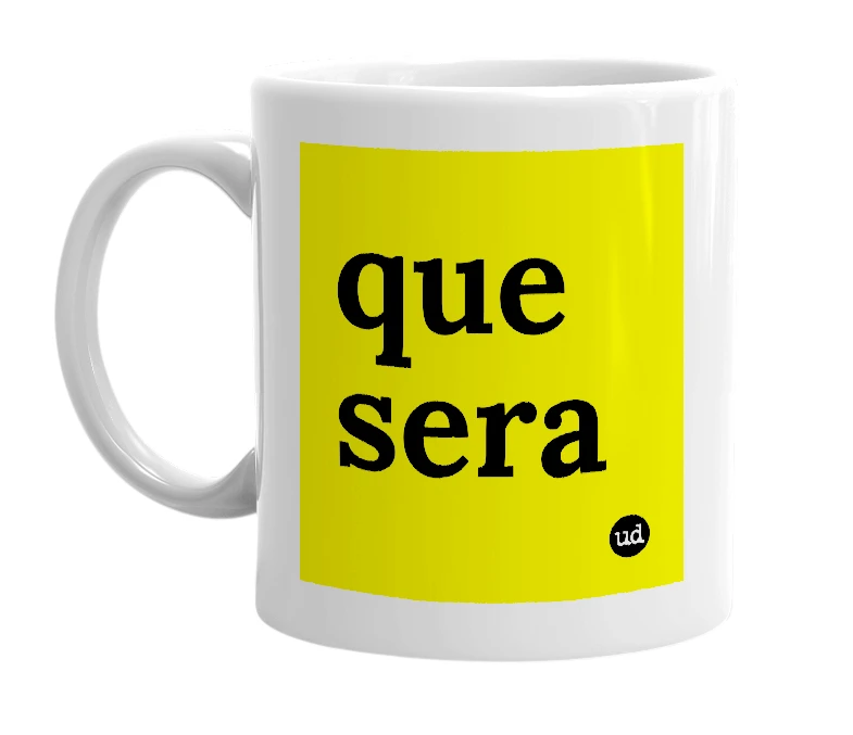 White mug with 'que sera' in bold black letters