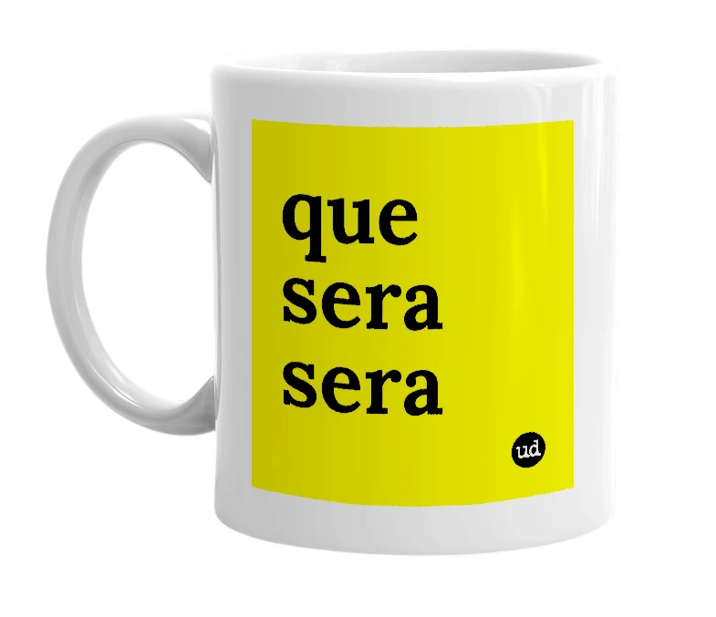 White mug with 'que sera sera' in bold black letters