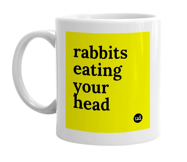 White mug with 'rabbits eating your head' in bold black letters