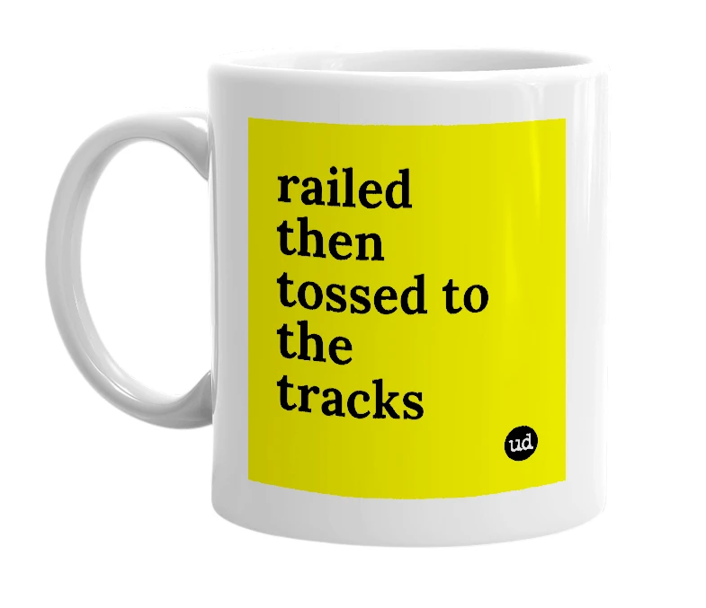 White mug with 'railed then tossed to the tracks' in bold black letters