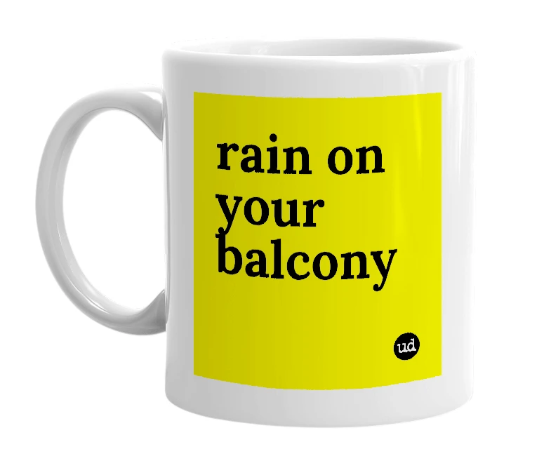 White mug with 'rain on your balcony' in bold black letters