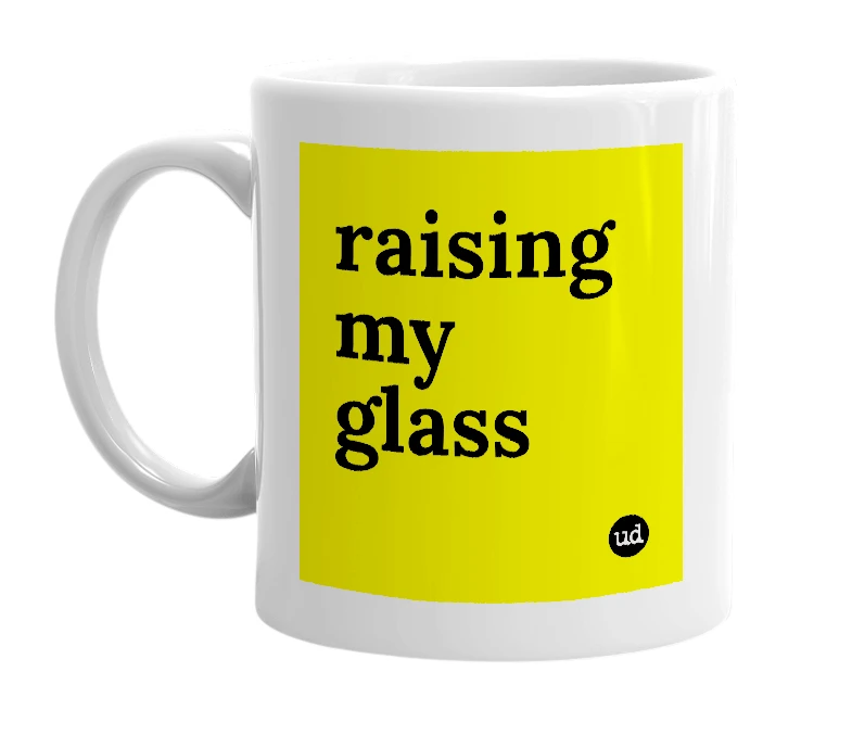 White mug with 'raising my glass' in bold black letters