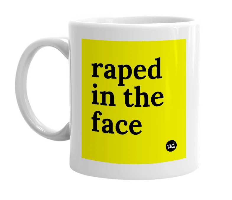 White mug with 'raped in the face' in bold black letters