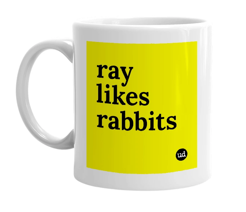 White mug with 'ray likes rabbits' in bold black letters