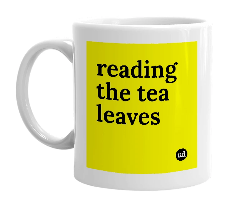 White mug with 'reading the tea leaves' in bold black letters