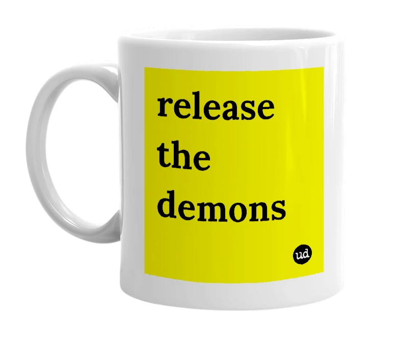 White mug with 'release the demons' in bold black letters