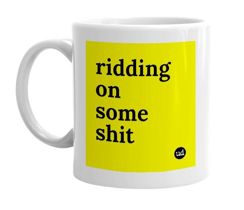 White mug with 'ridding on some shit' in bold black letters