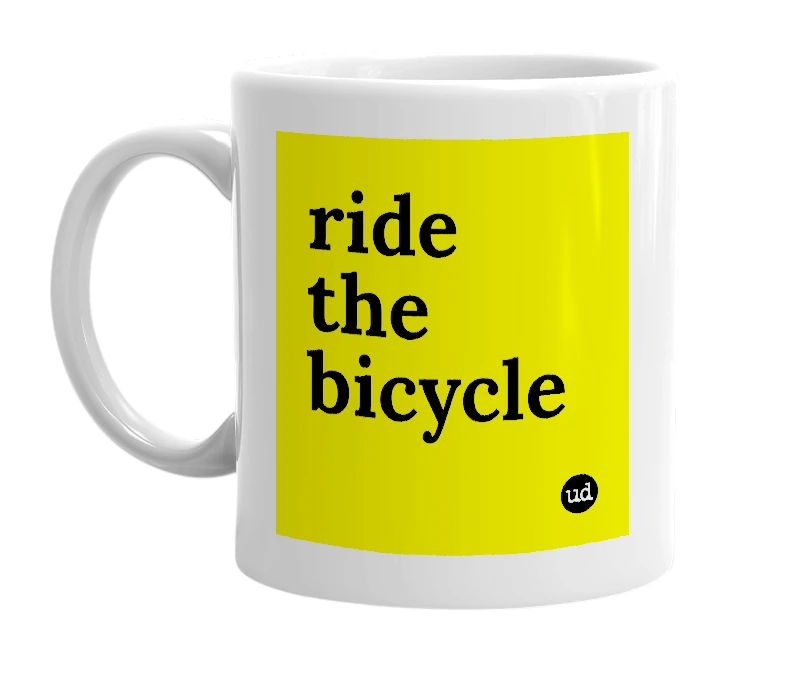 White mug with 'ride the bicycle' in bold black letters