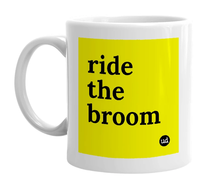 White mug with 'ride the broom' in bold black letters