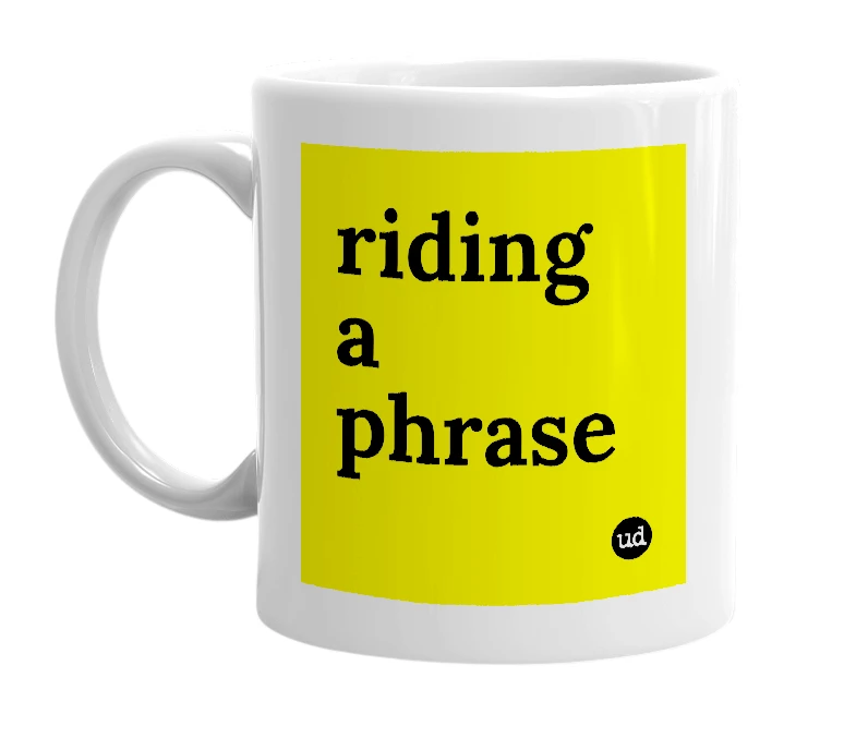 White mug with 'riding a phrase' in bold black letters
