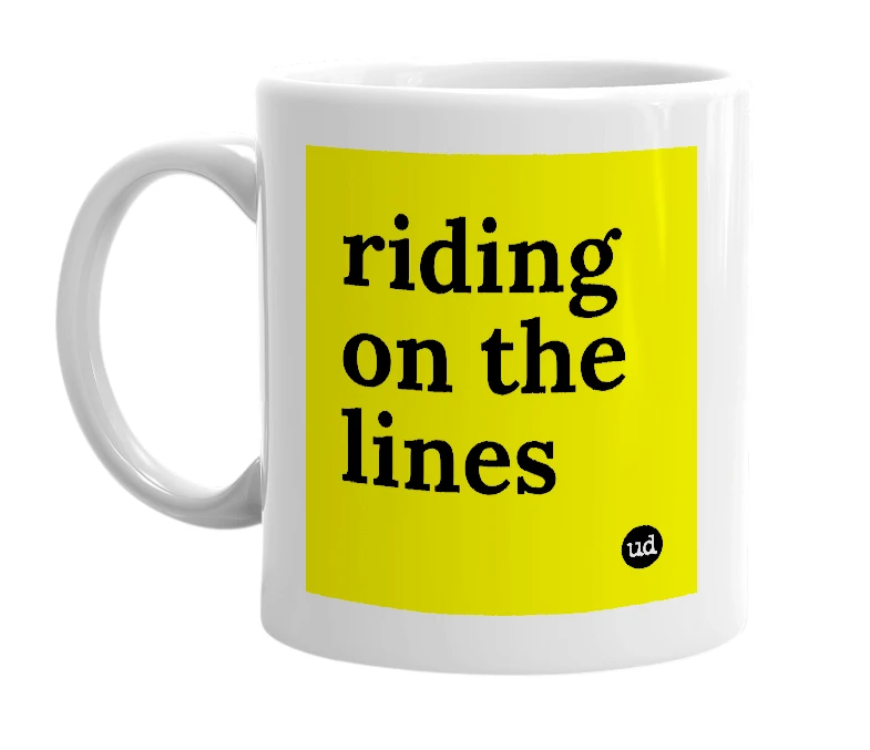 White mug with 'riding on the lines' in bold black letters
