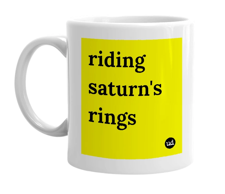 White mug with 'riding saturn's rings' in bold black letters