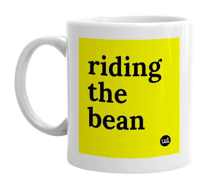 White mug with 'riding the bean' in bold black letters