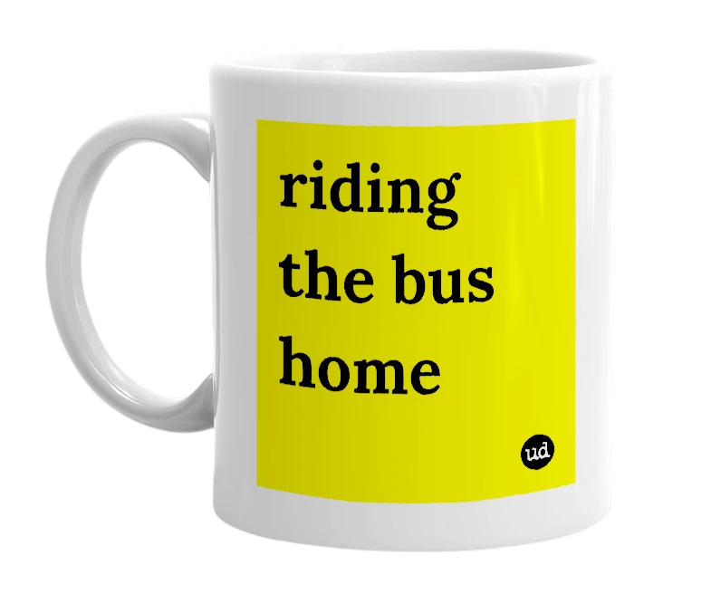 White mug with 'riding the bus home' in bold black letters