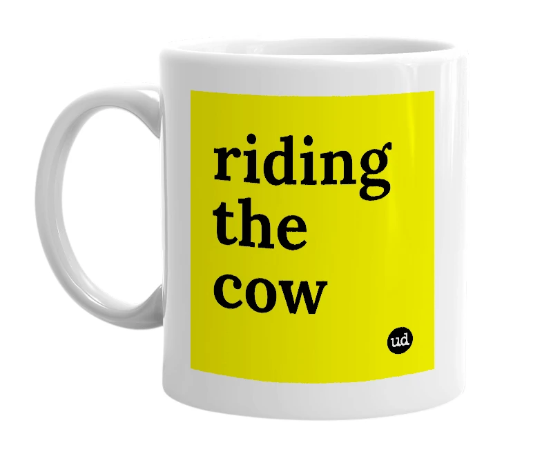 White mug with 'riding the cow' in bold black letters