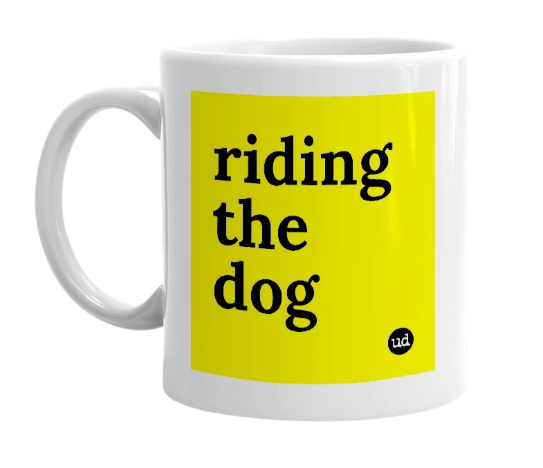 White mug with 'riding the dog' in bold black letters