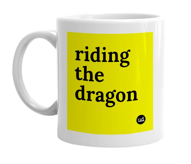 White mug with 'riding the dragon' in bold black letters