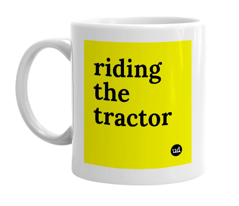 White mug with 'riding the tractor' in bold black letters