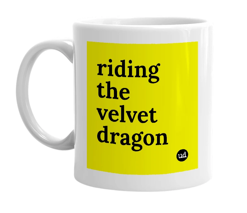 White mug with 'riding the velvet dragon' in bold black letters