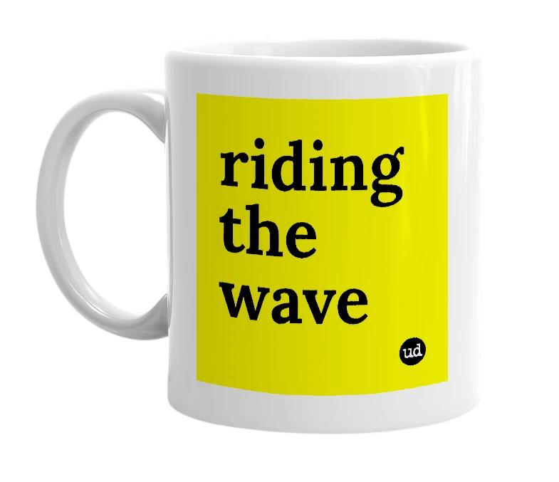 White mug with 'riding the wave' in bold black letters