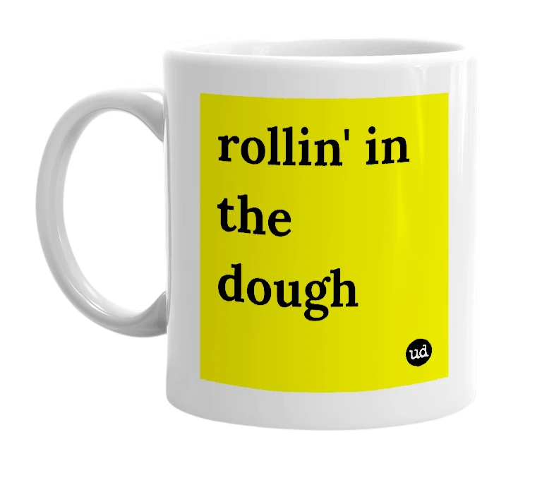 White mug with 'rollin' in the dough' in bold black letters