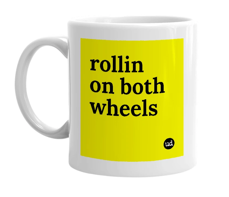 White mug with 'rollin on both wheels' in bold black letters