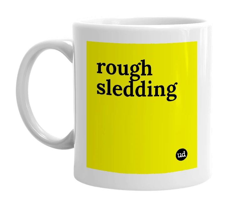 White mug with 'rough sledding' in bold black letters