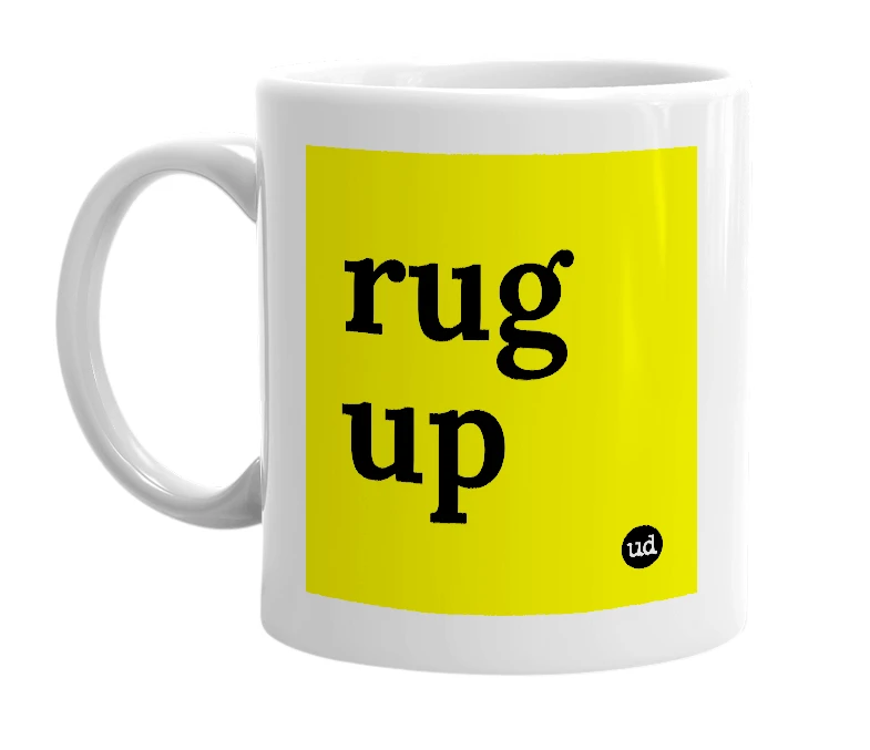 White mug with 'rug up' in bold black letters