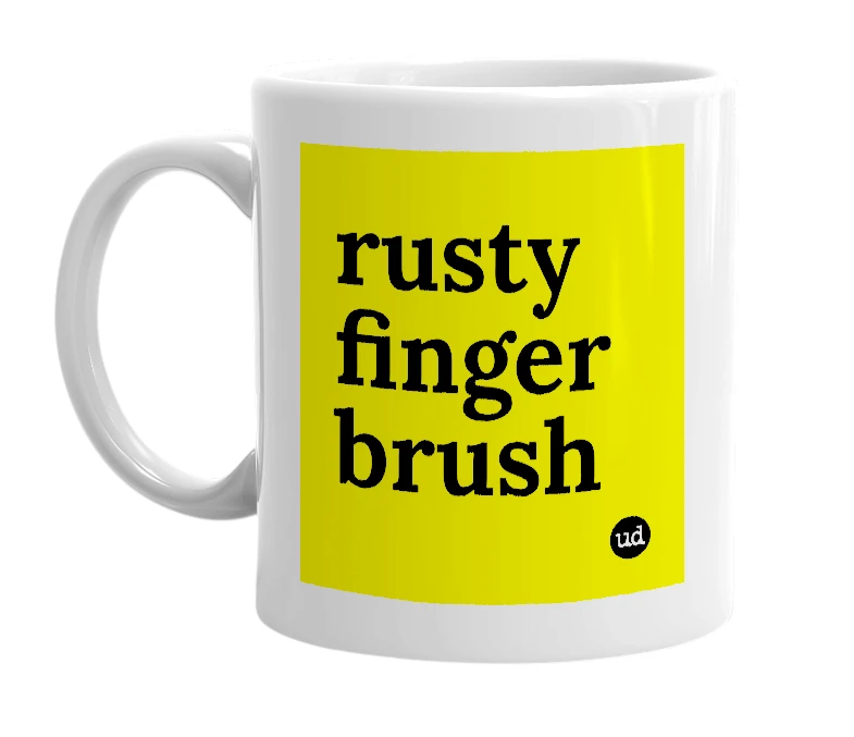 White mug with 'rusty finger brush' in bold black letters