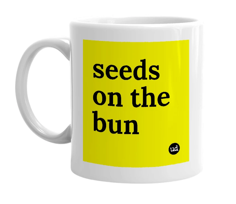 White mug with 'seeds on the bun' in bold black letters