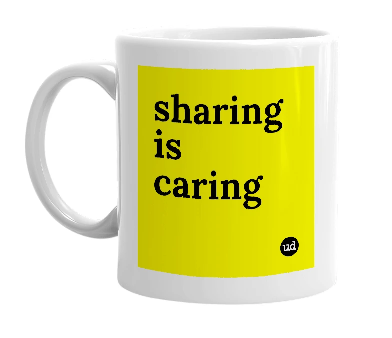 White mug with 'sharing is caring' in bold black letters