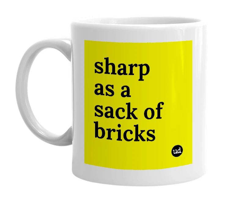 White mug with 'sharp as a sack of bricks' in bold black letters