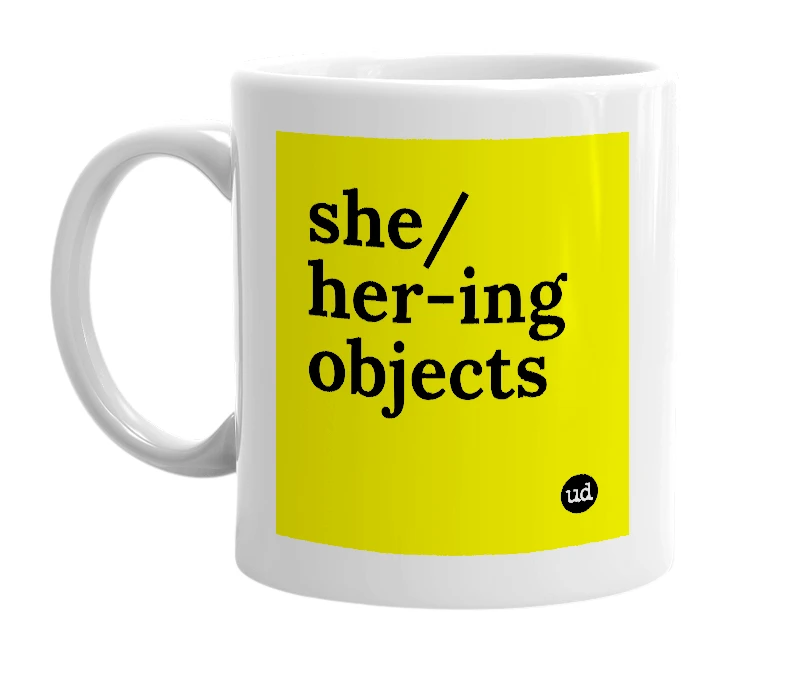 White mug with 'she/her-ing objects' in bold black letters