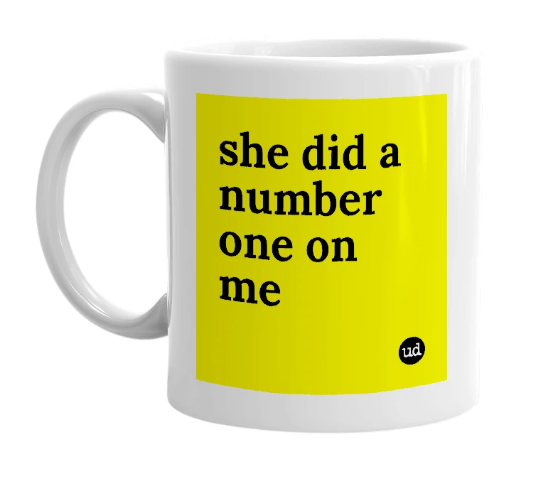 White mug with 'she did a number one on me' in bold black letters