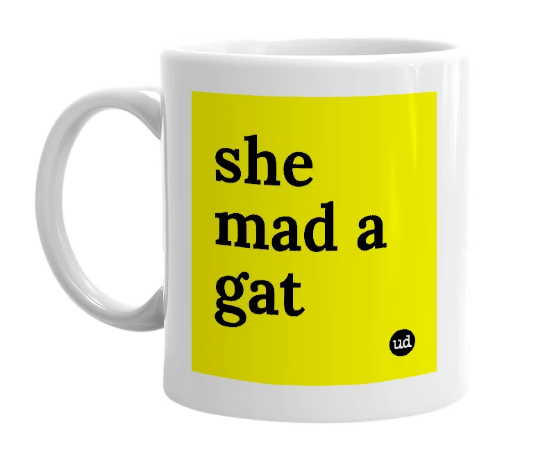 White mug with 'she mad a gat' in bold black letters