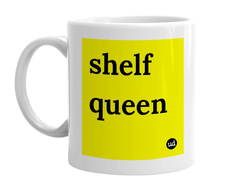 White mug with 'shelf queen' in bold black letters